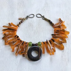 Necklace in coral orange shapes with ebony circle pendant