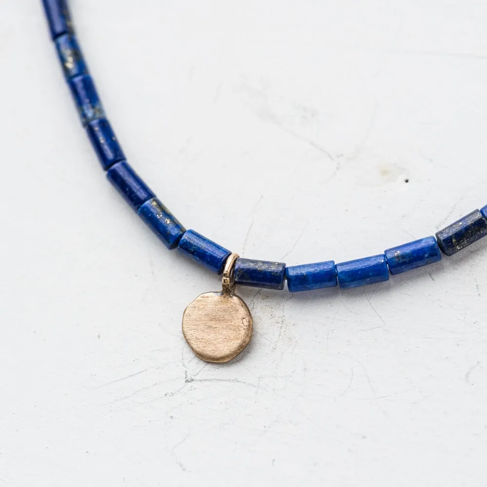 Petite Yellow Bronze Disc Necklace on Lapis Tube Strand