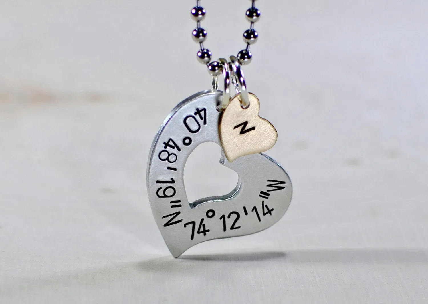 Sterling silver heart necklace with personalized latitude longitude coordinates with Bronze Heart Charm