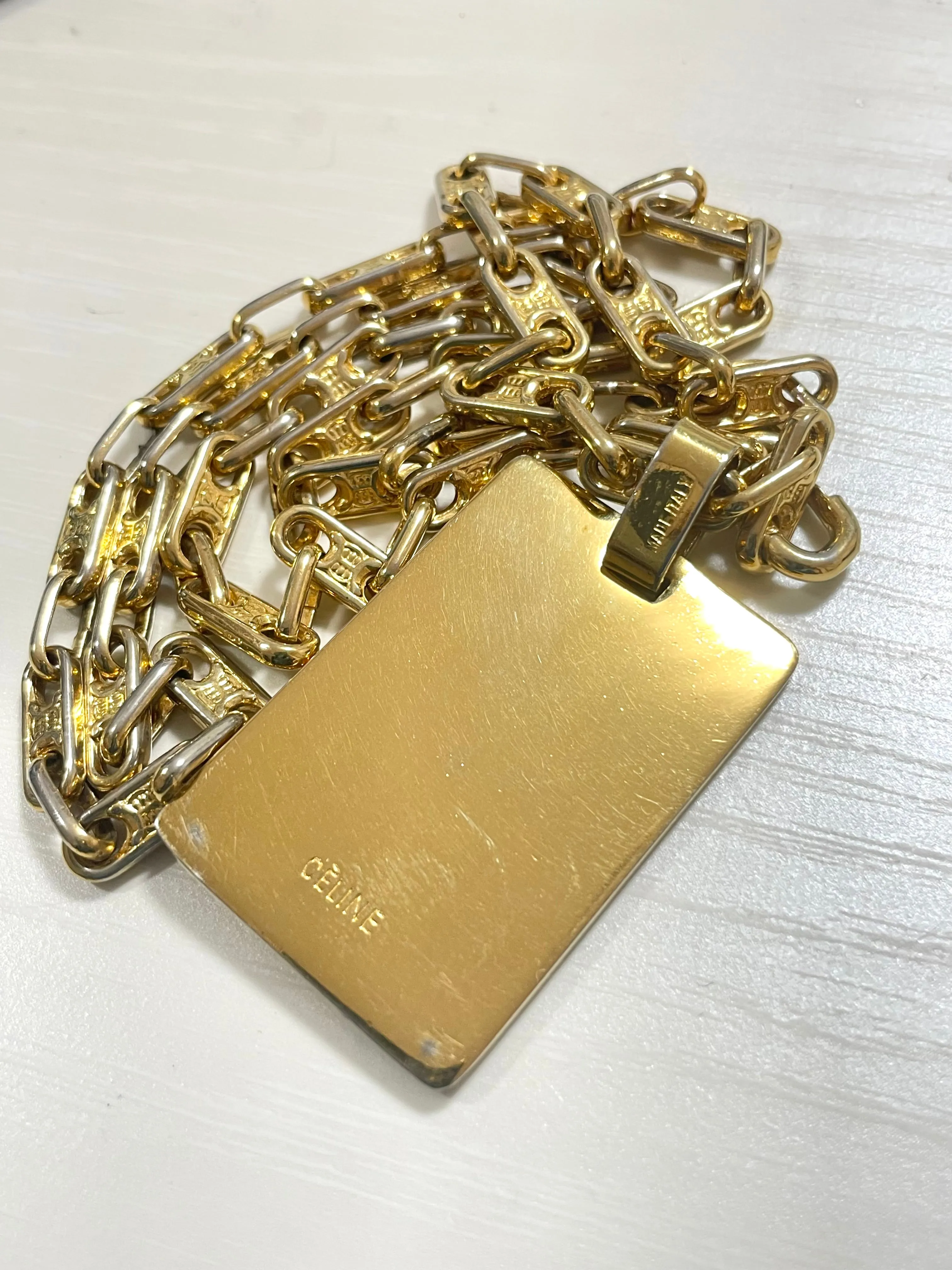Vintage Celine golden necklace with triomphe chains and a carriage and logo featured rectangular plate top. 070218ys2