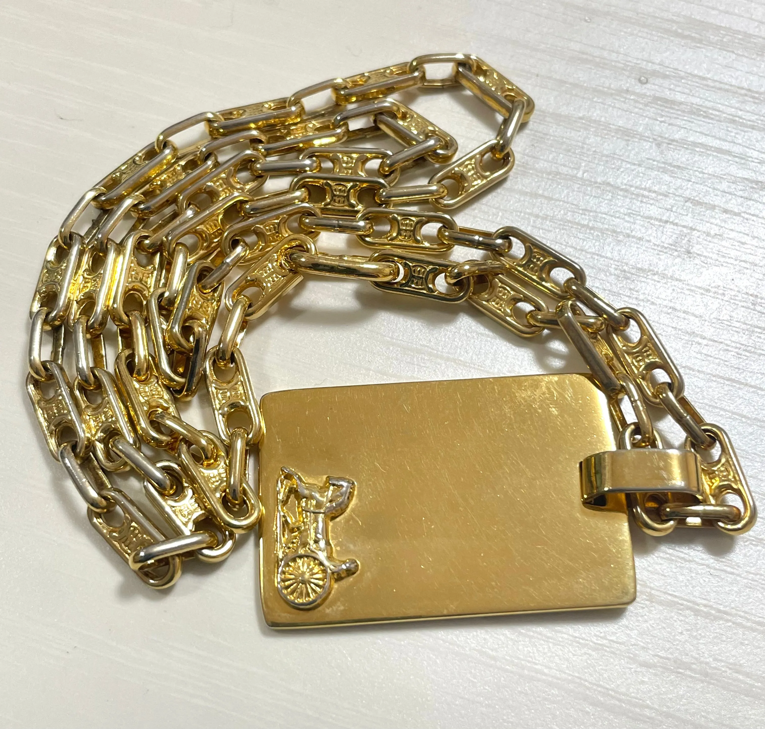 Vintage Celine golden necklace with triomphe chains and a carriage and logo featured rectangular plate top. 070218ys2